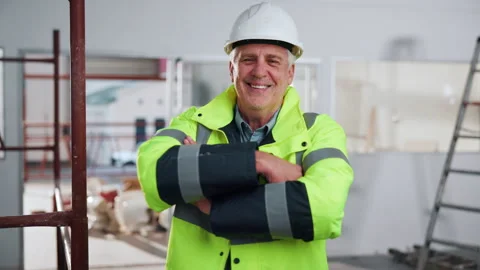 Crossed arms, man and face of construction worker on site by scaffolding with Stock Footage 341547020