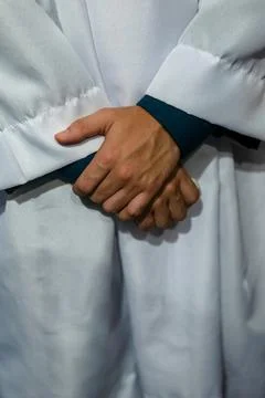 Crossed hands of an altar server in a prayerful posture. Stock-Fotos