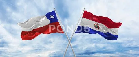 Crossed national flags of Chile and Paraguay flag waving in the wind at ...