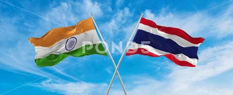 Crossed national flags of India and thailand flag waving in the wind at ...