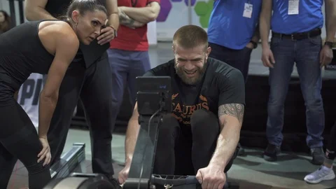 CrossFit athlete competing in a rowing machine discipline Stock Footage 111726629