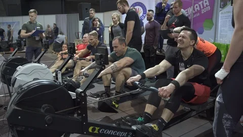 CrossFit athletes competing in a rowing machine discipline Stock Footage 111726666