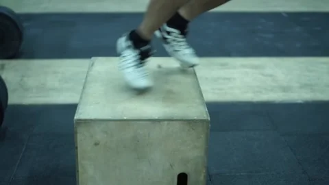 Crossfit class jumping on wooden boxes guided by trainer Stock Footage 131331283