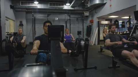Crossfit Gym Members Using Exercise Machines 2 Stock Footage 94971194