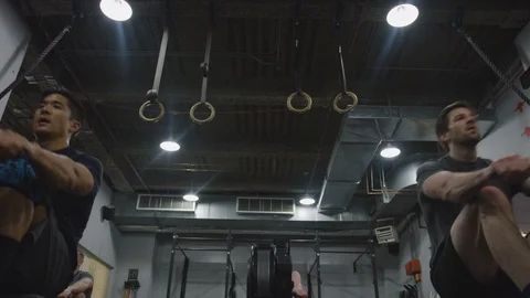 Crossfit Gym Members Using Exercise Machines 3 Stock Footage 94971309