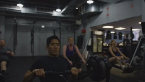 Crossfit Gym Members Using Exercise Machines 4 Stock Footage 94971739
