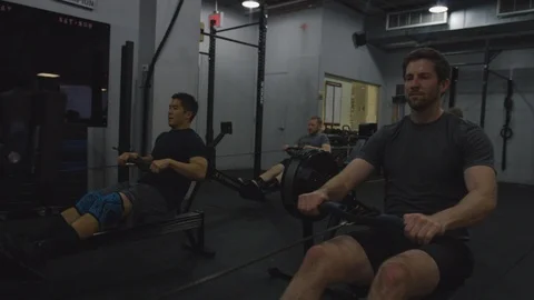 Crossfit Gym Members Using Rowing Machines Stock Footage 94989470