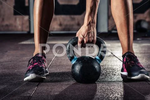 Crossfit kettlebell training in gym Stock Photos
