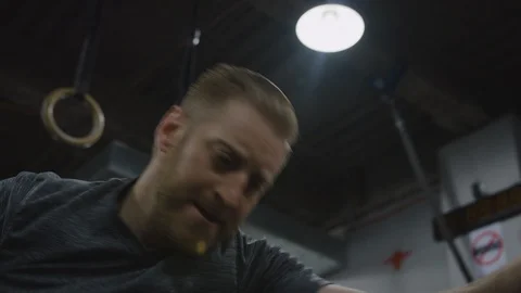 Crossfit Man in Gym Using Exercise Machine Stock Footage 94968631