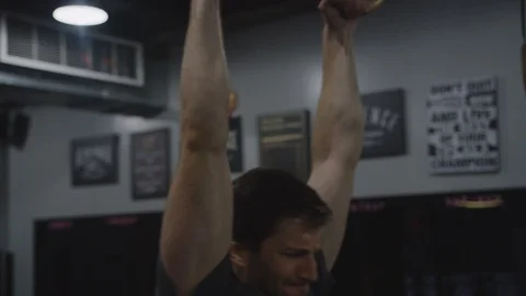 Crossfit Man in Gym Using Rings to Exercise 4 Stock Footage 94969700