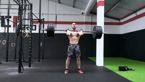 CrossFit / Weightlifting athlete doing a Squat Clean Stock Footage