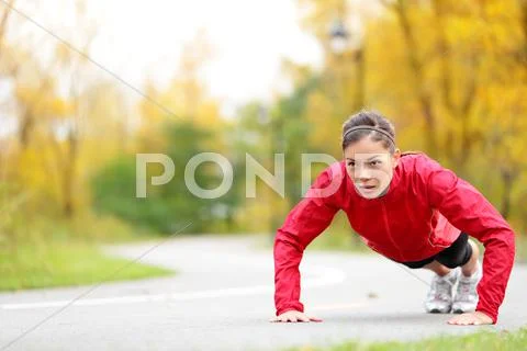 Crossfit woman doing push-ups Stock Photos