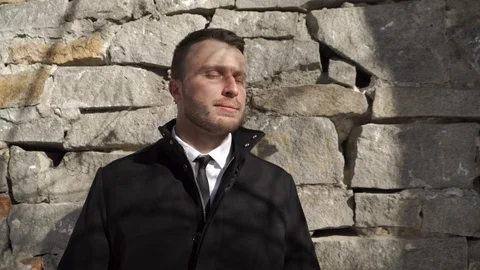 Crosshanded man is standing by the wall Video stock 88164149