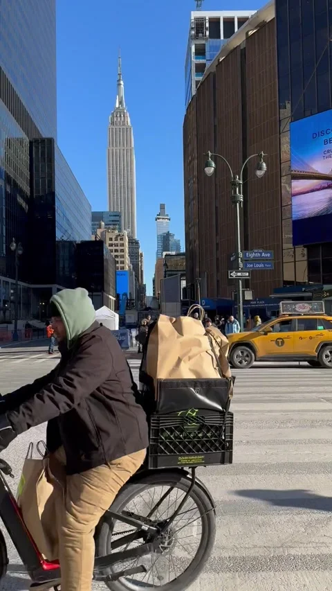 Crossing 34th St in front of Madison Square Garden and Empire State Building Stock Footage 262493702