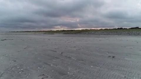 Crossing beach at sunset Stock Footage 95551176