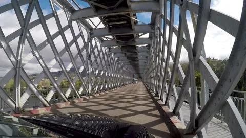 Crossing a bridge border between Portugal and Spain with blue sky Stock Footage 148699108