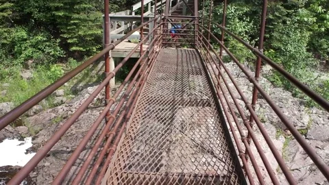 Crossing Bridge Over Waterfall Video stock 77760404