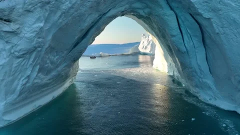 Crossing iceberg arch with drone Stock Footage 223564532