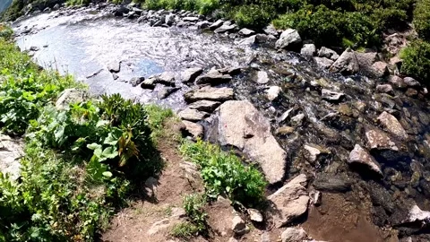 Crossing a mountain river in the first person Stock Footage 160959077