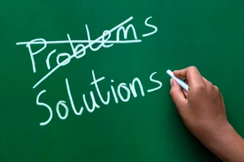 Crossing out problems and writing solutions on a blackboard. Stock Photos