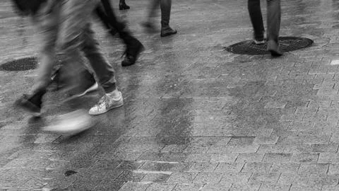 Crossing paths during rain Stock Photos