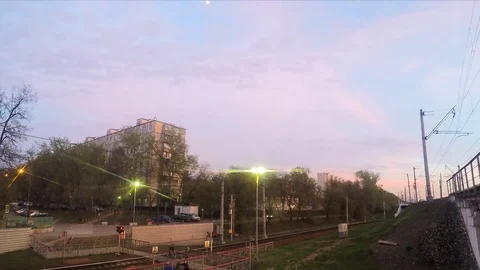 Crossing the railway and train at sunset timelapse Stock Footage 82985460