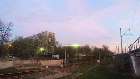 Crossing railway and train at sunset timelapse Stock Footage 82985518