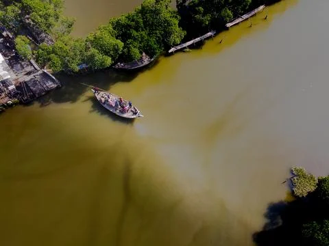 Crossing the river in a small boat Stock Photos