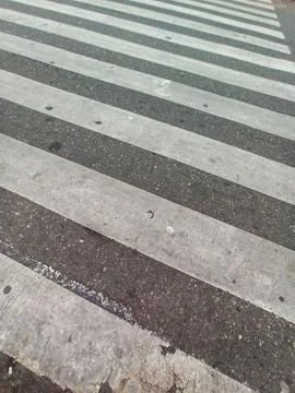 Crossing of road texture of pavement in perspective with white weathered pain Stock Photos