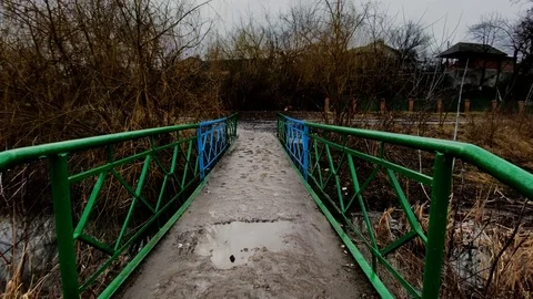 Crossing a small bridge over a river Stock Footage 125834292