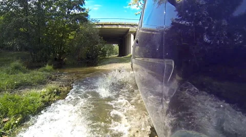 Crossing stream on a car. Stock Footage 42770642
