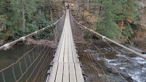 Crossing the Suspension Bridge over Cane Creek in Tennessee Stock Footage 90792477