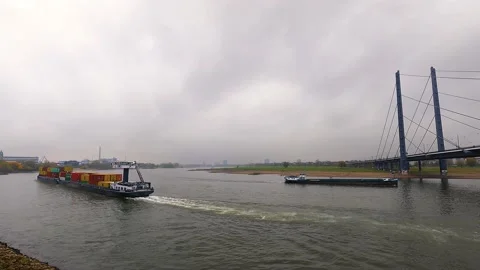 Crossing Two Cargo Ships on Cloudy Day: Dusseldorf Rhine Bridge View. Stock Footage 234349194