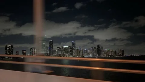 Crossing the William M Powell bridge with view of downtown Miami at night. 스톡 동영상 171052981