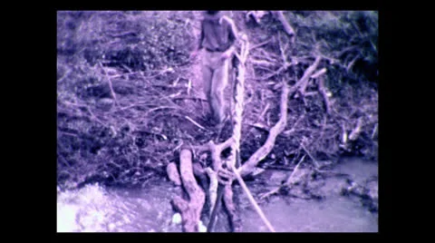 Crossing the Yadia River on log bridge, Tanzania 1937 動画素材 27150970