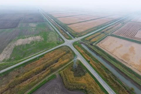 Crossroads paved roads through the fields. View from above Stock Photos