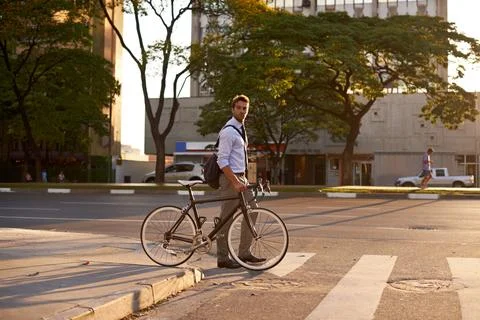 Crosswalk, bike and business man in city for morning, sustainable travel and Stock Photos