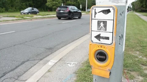 Crosswalk button large black silver circle yellow with illustration above Stock Footage 251358414