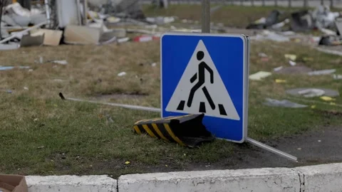 A crosswalk sign that has fallen over and is now lying on the ground. Stock Footage 196875452