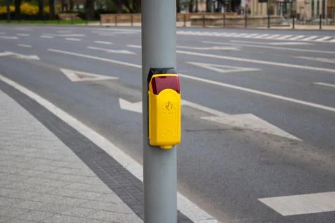 Crosswalk. Yellow button on a traffic light for pedestrians Stock Photos