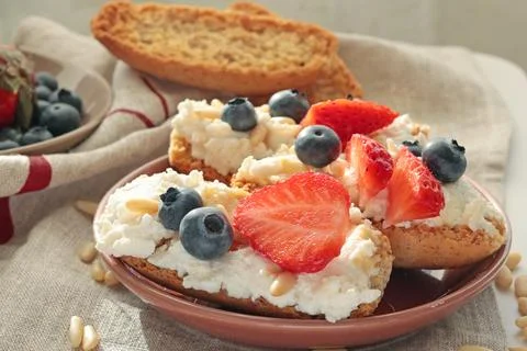 Crostini with ricotta, berries, pine nuts. Slices of toasted bread with cheese Stock Photos