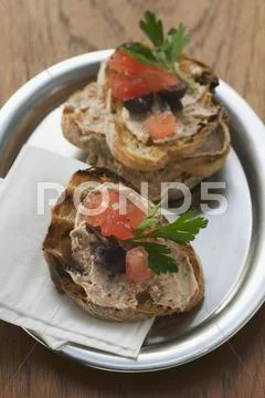 Crostini with tuna spread and tomato Stock Photos