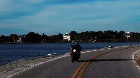 Crotchrocket crossing bridge next to shore Stock Footage 45290445