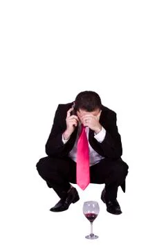 Crouched mediterranean man drinking Stock Photos