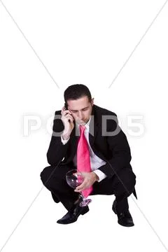 Crouched mediterranean man drinking Stock Photos