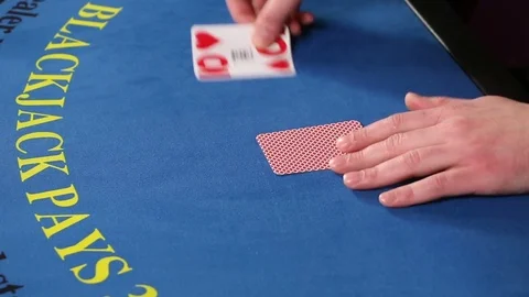Croupier placing black jack and poker cards on the casino table Stock Footage 71473600