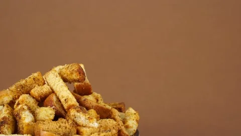Crouton or roasted crackers cubes rotating in wooden plate. Stock Footage 202237958