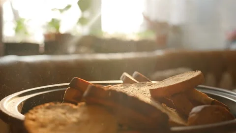 Croutons fall into a plate in slow motion. Close-up Stock Footage 144392311