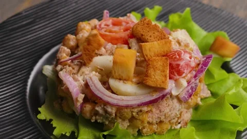 Croutons falling on tuna salad Stock Footage 310274397