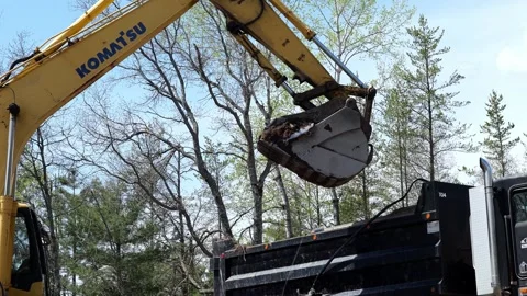 CROW WING CO, MN  11 MAY 2023: Excavator bucket scoops dirt closeup. Video stock 251059028